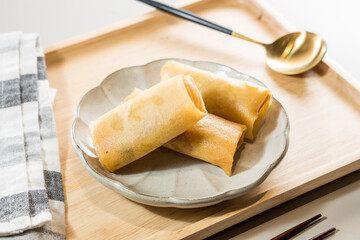 Fried Spring rolls on plate with chopsticks and spoon - Asian food style