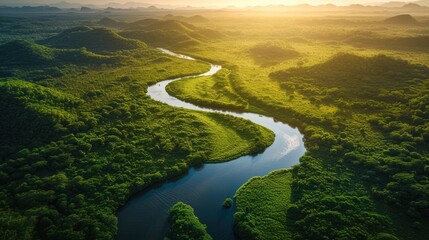Aerial view of a meandering river through a lush, green valley at sunset