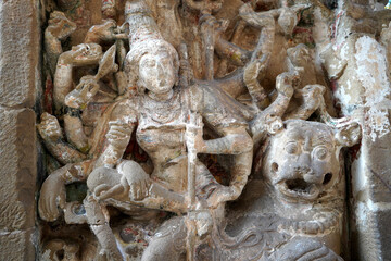 Sandstone sculpture of Hindu God with Lion carved in the walls of ancient Kanchi Kailasanathar temple in Kanchipuram, Tamilnadu.