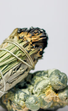California White Sage and Sweetgrass Ceremonial Herb Bundle Resting on Rough Natural Formation of Green Prehnite Crystal Gemstone Mineral Healing Energy Crystal Cleansing Spiritual 