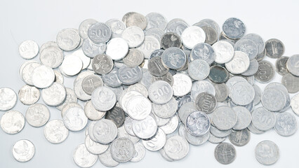 collection of Indonesian rupiah coins on a white background.