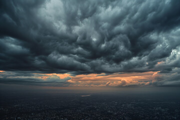 view of a city skyline under the threat of a brewing storm intense contrast between the dark, tumultuous storm clouds and the last rays of sunlight