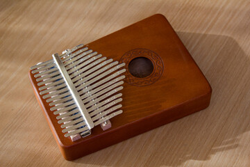 This is a kalimba placed on a wooden table.