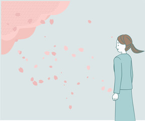桜の下のスーツ姿の女性