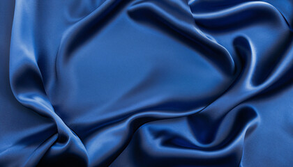 Obraz premium Beautiful dark blue silk satin background. Soft folds on shiny fabric. Luxury background with copy space for text, design. Web banner. Flat lay, top view table. Birthday, Christmas, Valentine's Day.