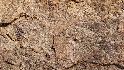 Brown stone background. Rock texture. Mountain surface. Close-up. Stone wall. Wide banner with copy space for your design.