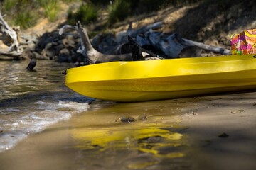 yellow canoe and kayak on a sandy beach in Australia in summer. kayaking on the sea in tasmania