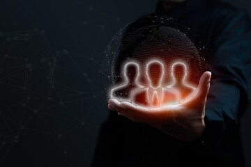 Teamwork concept. Businessman showing people icons representing teamwork on palms on black background.