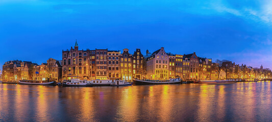 Obraz premium Amsterdam Netherlands, night panorama city skyline of Dutch house at canal waterfront
