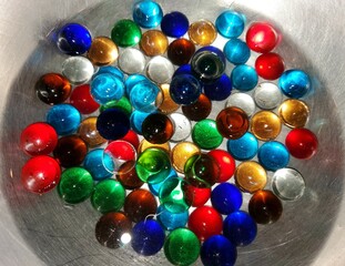 A pile of colorful and shiny glass marbles