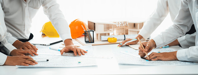 Worker, architect and engineer work on real estate construction project oratory planning with...