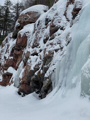 Frozen waterfall in the mountains in winter. Beautiful winter landscape.