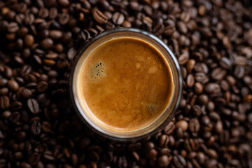 Coffee cup and coffee beans on dark background. Top view.