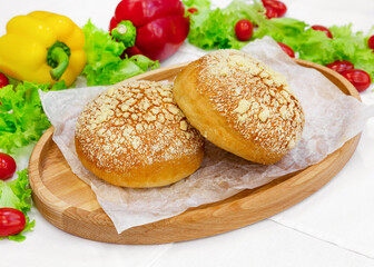 Bun, bun with sprinkles, pastry on wooden board