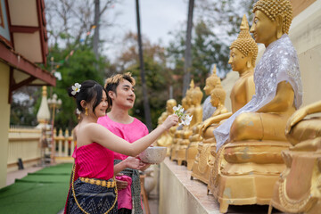 Songkran Day, young Thai people wear Thai costumes to bathe Buddha statues and play on Songkran Day.