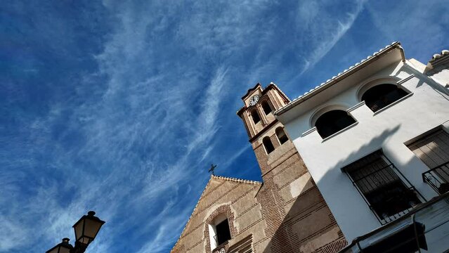 Light clouds passing over Spanish clock tower Time Lapse
