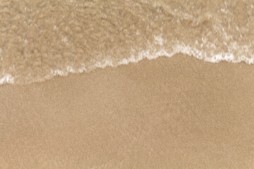 Beach sand texture with sea water, closeup