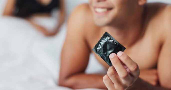 Man, condom and contraception for safety in bedroom, smile and proud for responsible choice at home. Couple, security and happy for protection with rubber and prevention of hiv and sexual illness