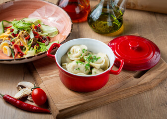 Homemade dumplings with meat and salad on the table, cafe, lunch