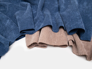 Multicolored fabrics folded in a stack . Multi-colored corduroy textile. Velvet.