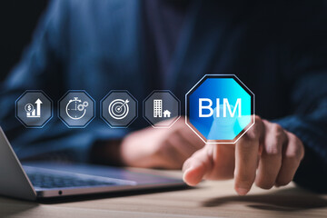 BIM or Building information modeling technology concept. Businessman using laptop with virtual screen BIM icons.