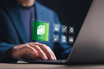 LCA or Life cycle assessment. Person use laptop with virtual screen of LCA icons for assessing environmental impacts associated on value chain product. Carbon footprint evaluation and ISO LCA standard