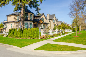 two story stucco luxury house with nice summer  landscape in Vancouver, Canada, North America.