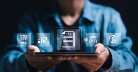 Calculation tax return taxes and VAT. Businessman use tablet with virtual TAX icons for calculates...
