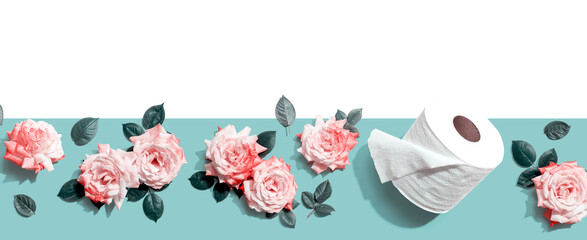 Toilet paper with pink roses overhead view - flat lay