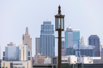 Fototapeta na wymiar A historic street lamp frames a morning view of the downtown skyline of Kansas City, Missouri, USA.