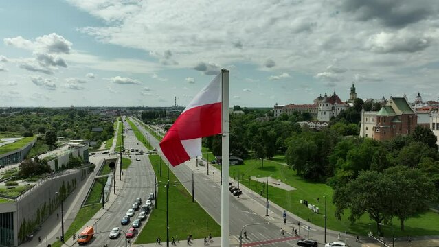 Polish Flag Over Urban Landscape: A Symbol of Pride and History