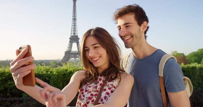 Smile, kiss and couple selfie at Eiffel Tower in Paris, France together for honeymoon, romance or bonding. Date, love or happy with young man and woman outdoor for travel, vacation or holiday