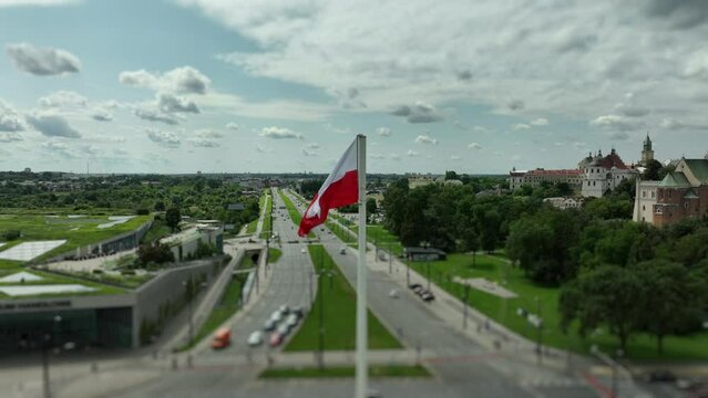 Polish Flag Over Urban Landscape: A Symbol of Pride and History