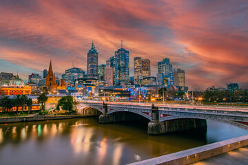 Fototapeta na wymiar Melbourne Skyline behind Flinders Street Station and the Yarra River at Sunset. 