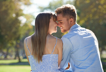Couple, nose touch and relax in park with happiness outdoor, love and commitment for healthy...