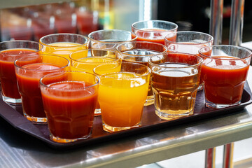 Glasses of juice on display on the table in a canteen