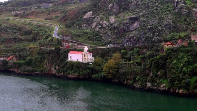 Lonely waterfront chappel of Capela do Senhor de Alem. Porto, Portugal
