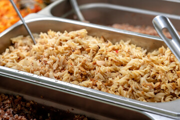 Metal trays with fresh food in a canteen