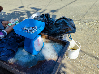 small fish, (anchovies) carried by traveling fish sellers on scales on their motorbikes