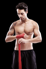 Man, hand wrap and fitness with fighter in a studio ready for boxing training and workout. Body, athlete and male boxer from Brazil with exercise, sport and wellness for battle with black background