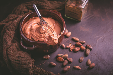 Chocolate cream cheese mousse in a bowl with whisk, preparing healthy homemade sugar free snack