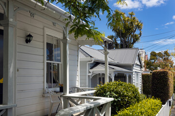 Porches. White fence in front of Victorian wooden houses at Richmond road. Auckland New Zealand. 
