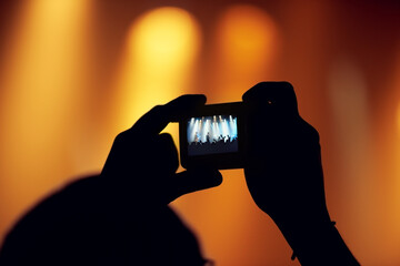 Hands, cellphone or image of band at concert, music event or audience with flashlight in bokeh....