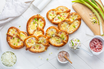 Homemade delicious traditional Bavarian Brezeln or pretzels baked with cream cheese, bacon and onions