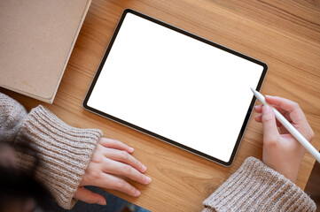 Top view image of a woman using a digital tablet at her desk. people and technology concepts