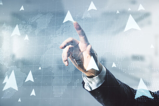 Double exposure of male hand presses on abstract virtual world map with pins hologram on blurred office background. Geolocation tracking and transportation concept