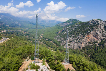 Wireless communication tower antenna in mountain location, satellite transmits the signals of...