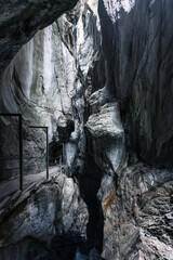 Natural limestone cave in the canyon and pathway in Rosenlaui glacier gorge at Switzerland