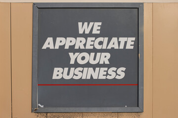 Weathered "We Appreciate Your Business" signage at the storefront.