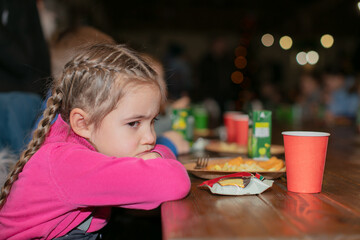 Sad little girl doesn't want to eat food.